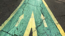 Close up arrow signs on asphalt city road